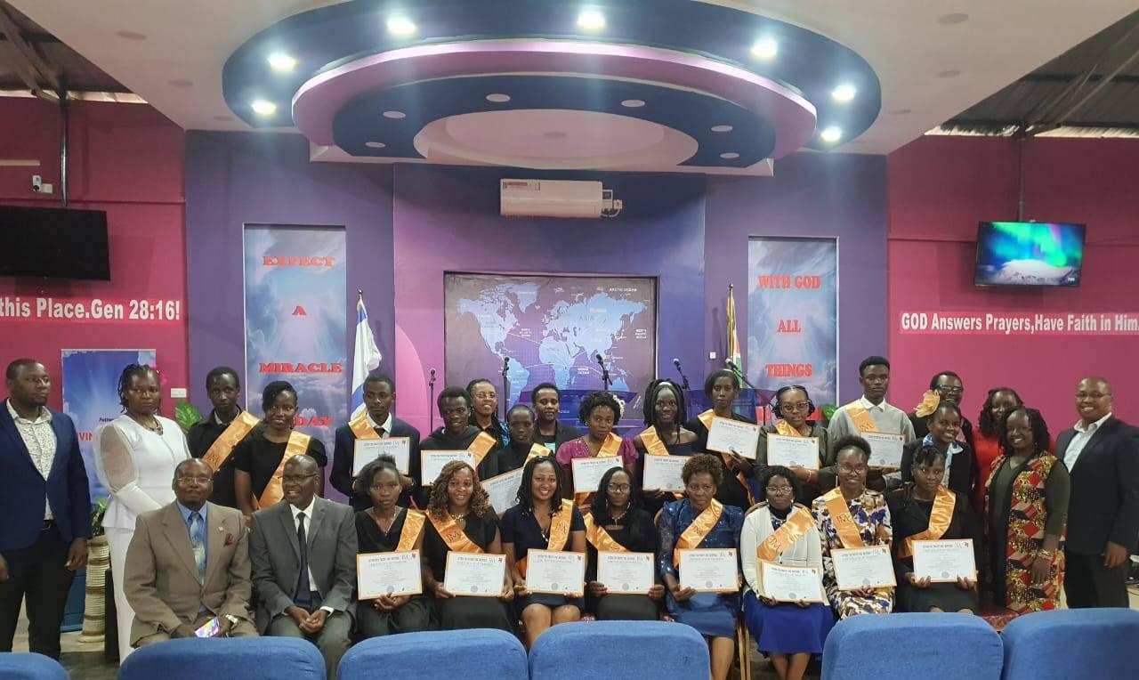 Teachers proudly holding their certificates after graduating from Children Ministers Institute